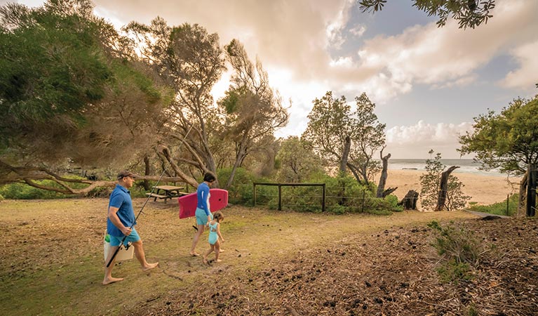 Family at Haycock Point picnic area, walking to the nearby beach. Photo: John Spencer/DPIE