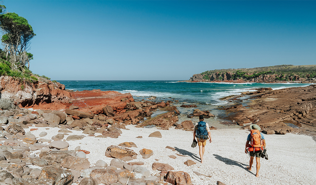 Hikers arriving at Hegartys Bay, a small rocky beach. Credit: Remy Brand/DCCEEW &copy; Remy Brand
