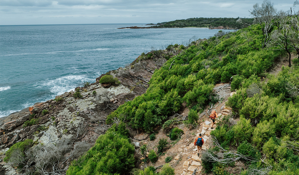 Hikers walking past Bobs Rock along the Light to Light Walk. Credit: Daniel Parsons/DCCEEW &copy; Daniel Parsons