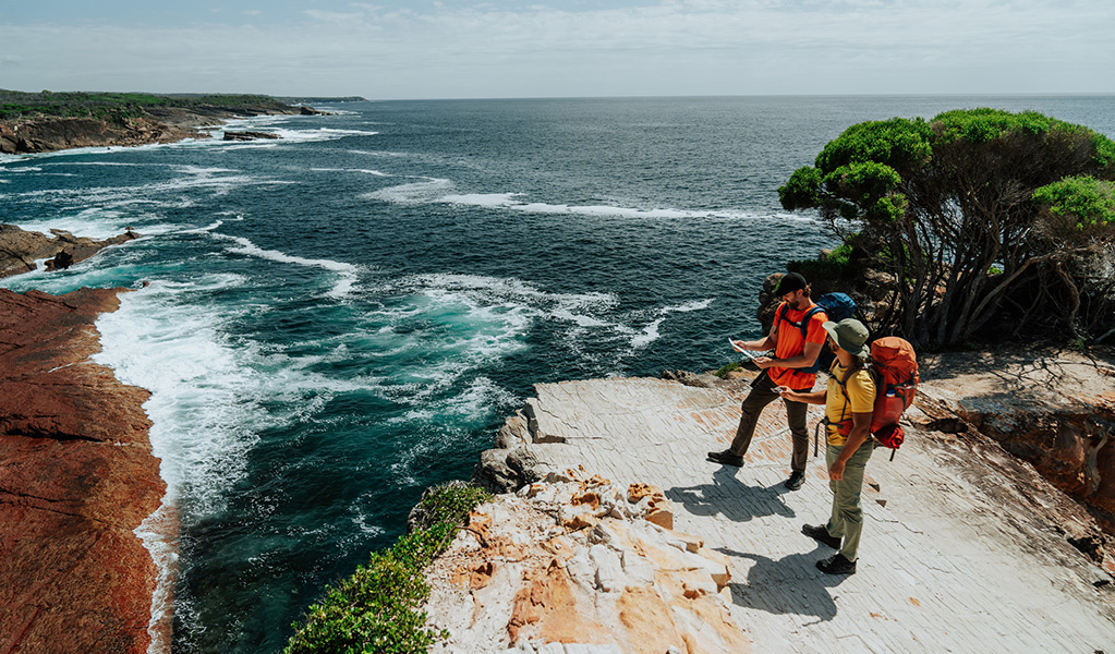 Hikers standing on Pulpit Rock in Beowa National Park. Credit: Remy Brand/DCCEEW © Remy Brand