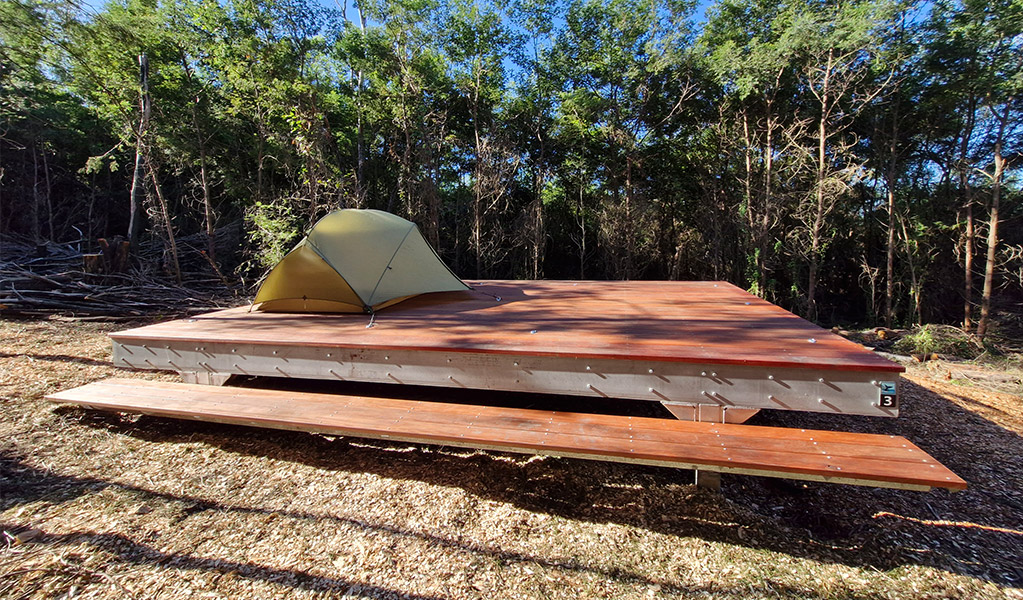 A hardwood tent platform at Hegartys Bay campground. Credit: Sam Doherty © DCCEEW