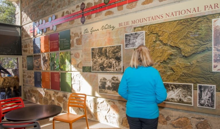 A woman looking at the displays in Blue Mountains Heritage Centre. Photo: John Spencer &copy; DPIE