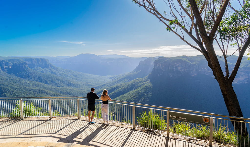 Two visitors looking out at the view of Grose Valley from Evans lookout in Blue Mountains National Park. Photo credit: Simone Cottrell/DPE &copy; DPE