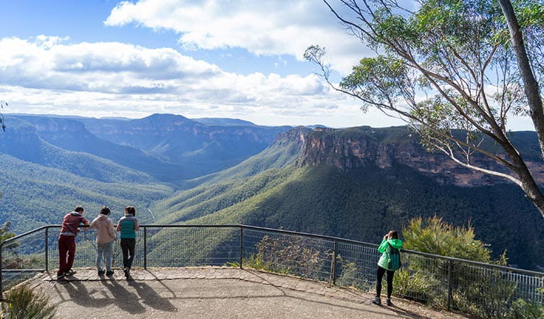 Visitors enjoy the views from Evans lookout, Blue Mountains National Park. Photo: Simone Cottrell &copy; DPE