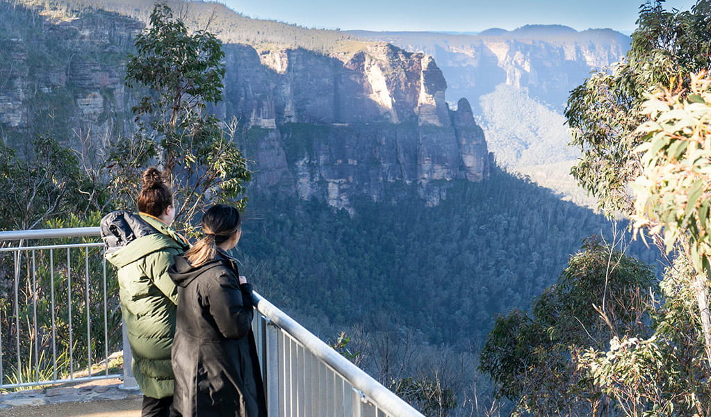 2 visitors at Govetts Leap Lookout among the treetops taking in the view of Grose Valley. Simone Cottrell/DPE &copy; DPE