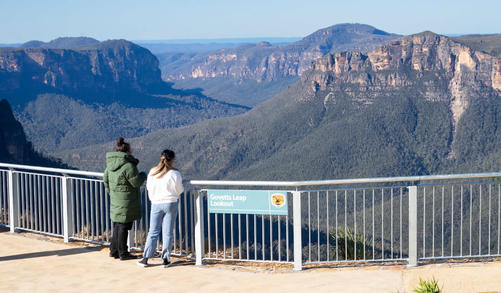 2 visitors at Govetts Leap lookout taking in the view of Grose Valley in the background. Simone Cottrell/DPE &copy; DPE