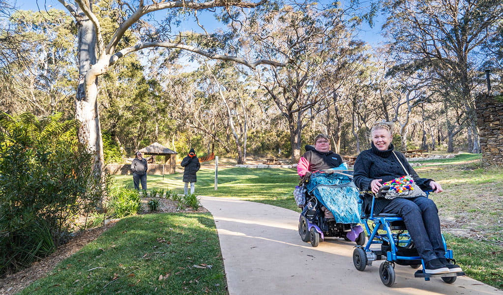 Visitors using wheelchairs on a path in the picnic area at Govetts Leap lookout. Credit: Simone Cottrell/DPE &copy; DPE