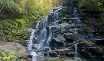 Water cascades over rock ledges at Empress Falls at the end of Empress Canyon in Blue Mountains National Park. Photo credit: David Finnegan &copy; DPIE