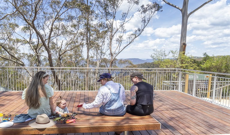 A group of friends at Valley of the Waters lookout in the Katoomba area of Blue Mountains National Park. Photo: Simone Cottrell &copy; DPE 