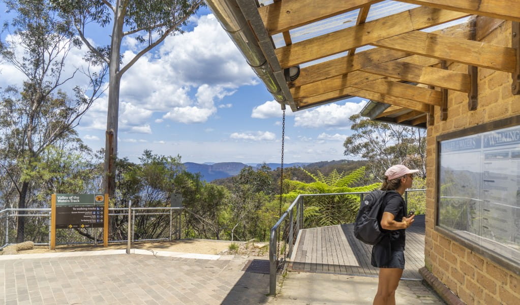 A person reads signage at the start of the Valley of the Waters track in Blue Mountains National Park. Photo: Simone Cottrell &copy; DPE