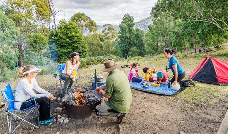 Children and adults gather beside a campfire at Dunphys campground, Blue Mountains National Park. Photo: Simone Cottrell/OEH.