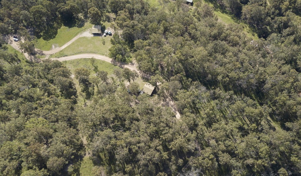 Aerial shot of Galong cabins surrounded by remote wilderness in the Southern Blue Mountains area of Blue Mountains National Park. Photo: Simone Cottrell &copy; DPIE