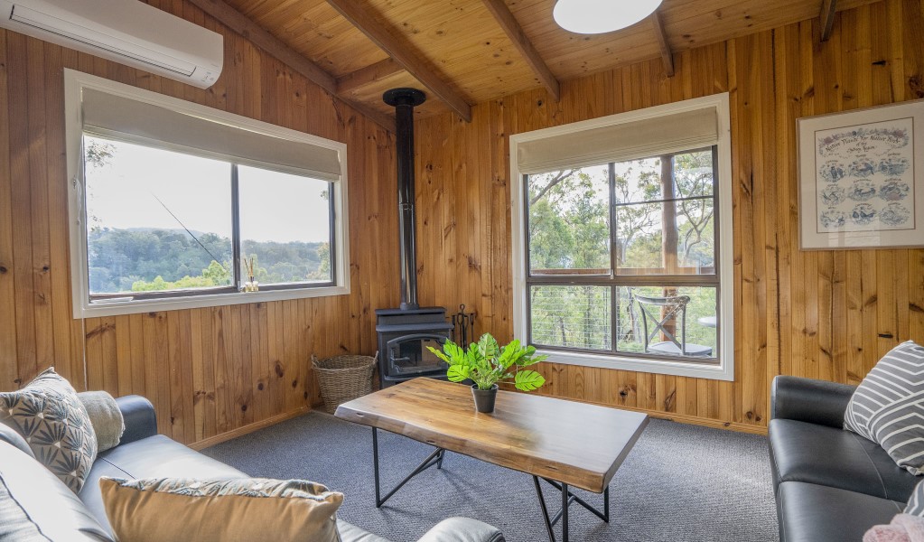 The lounge room in Galong cabins with fireplace and reverse-cycle air conditioning. Photo: Simone Cottrell &copy; DPIE