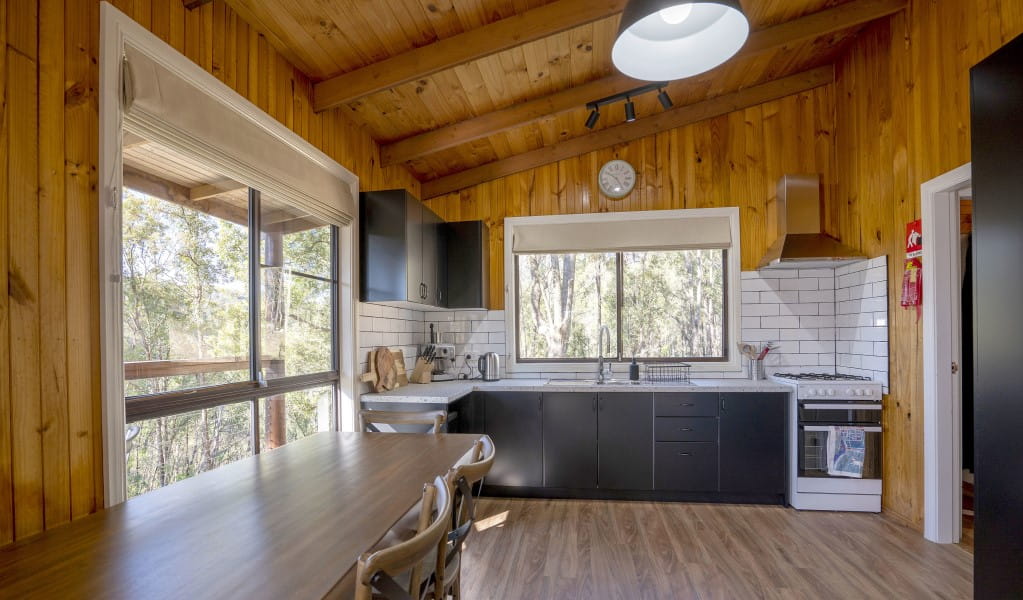 The fully-furnished kitchen and dining table at Galong cabins. Photo: Simone Cottrell &copy; DPIE