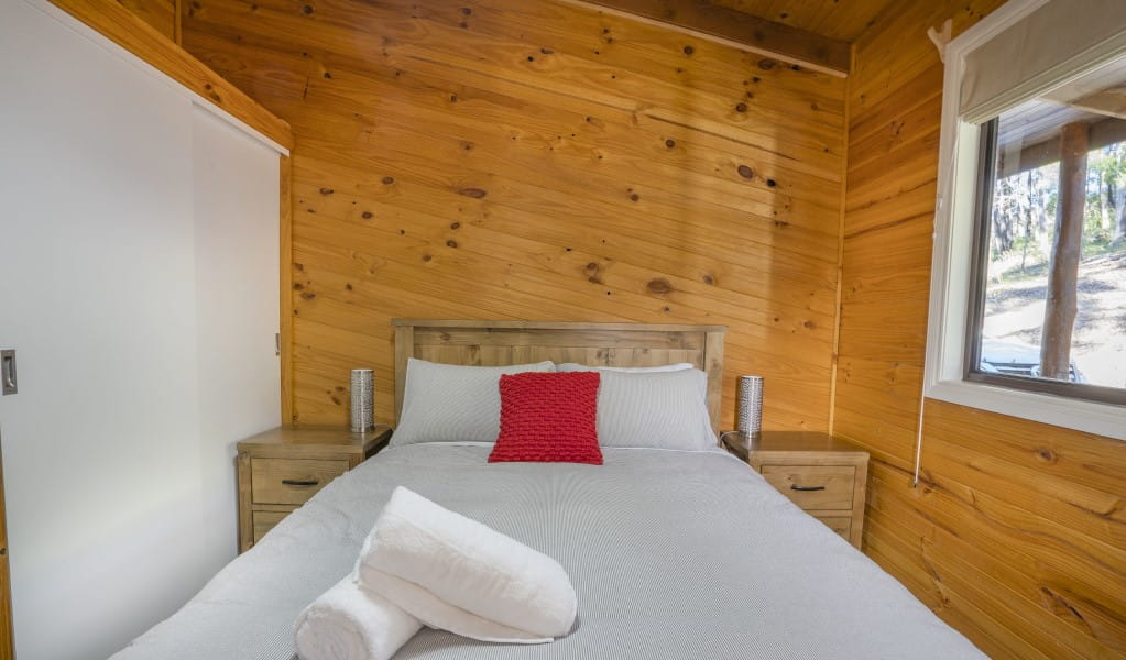 A bedroom with queen bed in Galong cabins, Blue Mountains National Park. Photo: Simone Cottrell &copy; DPIE