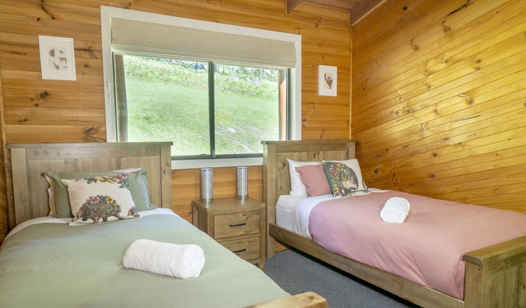 A bedroom with 2 king single beds in Galong cabins, Blue Mountains National Park. Photo: Simone Cottrell &copy; DPIE