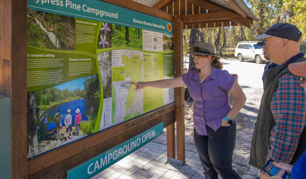 Visitors reading the Cypress Pine campground sign. Credit: Joshua J Smith &copy DPIE