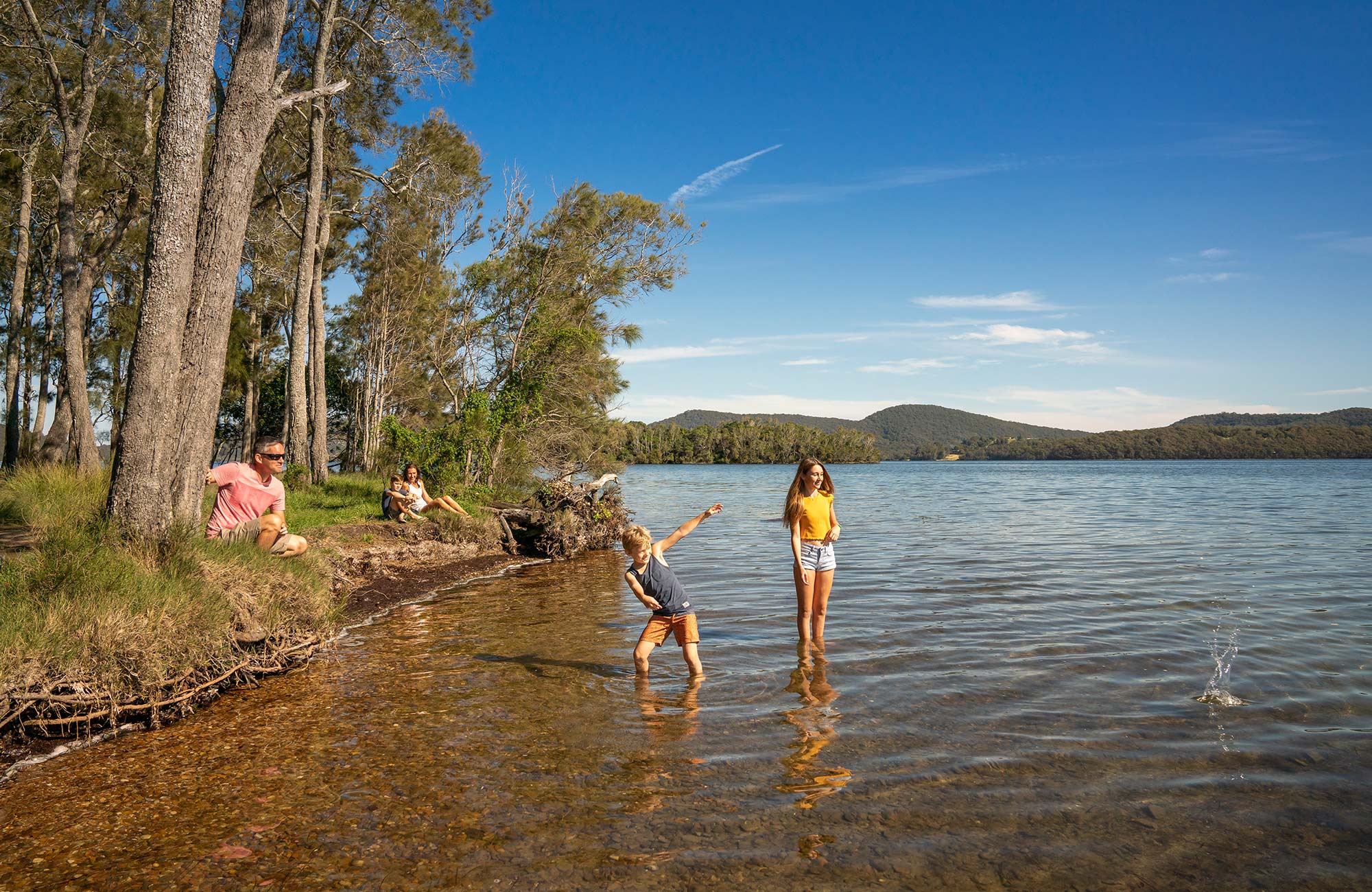 A family on the shores of Wallis Lake in Booti Booti National Park. Photo credit: John Spencer &copy; DPIE