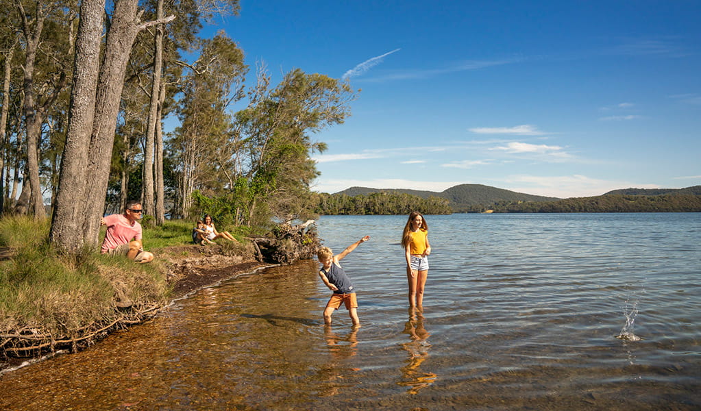 A family plays on the shore of Wallis Lake, in Booti Booti National Park. Credit: John Spencer &copy; DPE