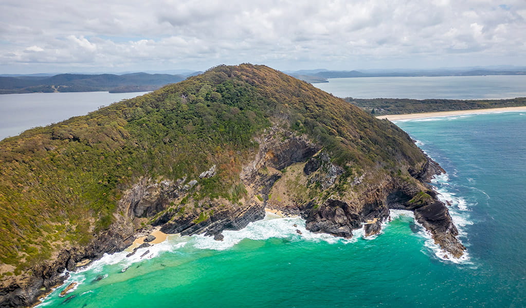 An aerial view of the rugged coastline in Booti Booti national park with Wallis lake in the background. Credit: John Spencer &copy; DPE