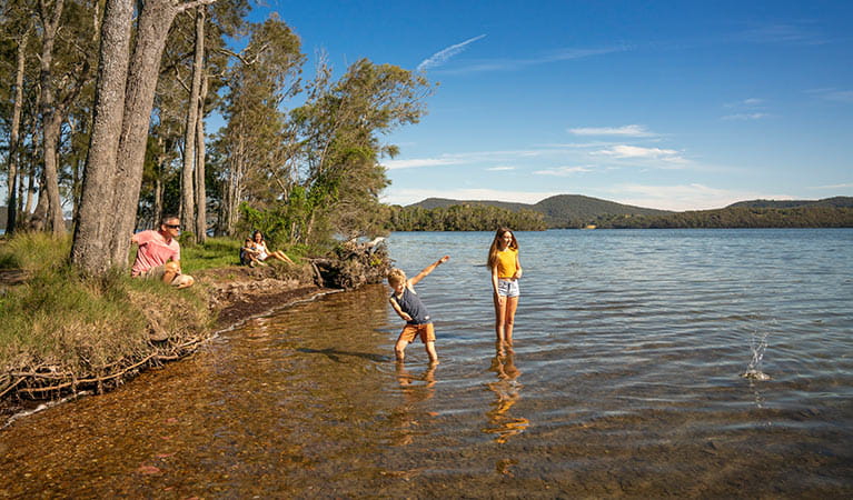 A family plays on the shore of Wallis Lake, in Booti Booti National Park. Photo credit: John Spencer & copy; DPIE