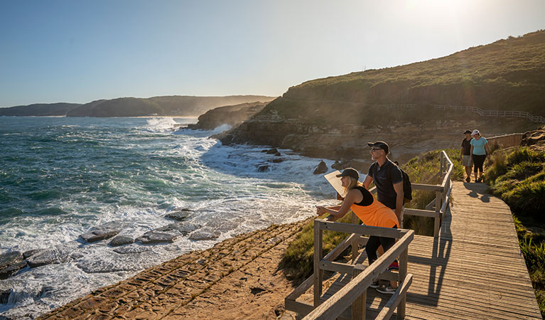 Two couples enjoying the view at a lookout along Bouddi coastal walk in Bouddi National Park. Photo: John Spencer &copy; OEH