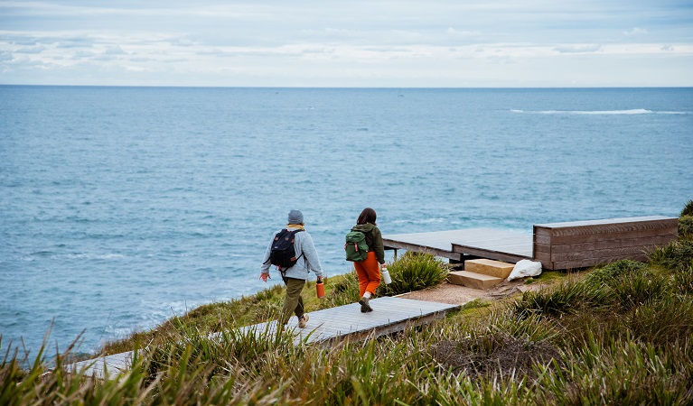 Visitors walking along the coast at Dadar lookout, Bouddi National Park. Photo: Jared Lyons © DPE