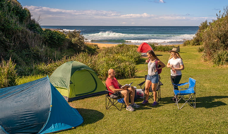 People nearby tents located at Little Beach campground, Bouddi National Park. Photo: John Spencer/DPIE.