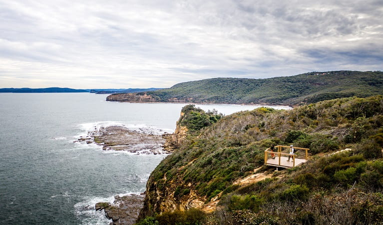 Visitors taking in panoramic coastal views from Mullian lookout. Photo: Daniel Parsons © DPE