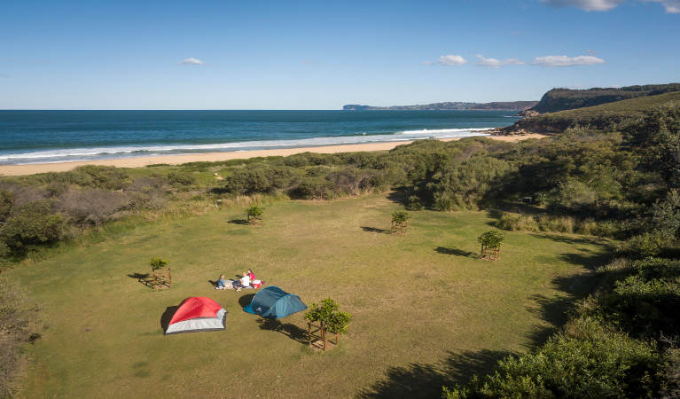 Aerial view of tents and ocean in the distance at Tallow Beach campground. Photo credit: John Spencer. <HTML>&copy; DPIE