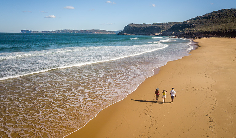 Aerial view of 3 people walking along Tallow Beach, Bouddi National Park. Photo: John Spencer/DPIE.