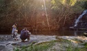 A family of four stops to admire the falls at the base of Somersby Falls walking track, Brisbane Water National Park. Credit: Stuart Cohen, Bottle Brush Media © DCCEEW