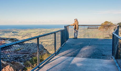 A man stands at Jamberoo lookout, Budderoo National Park. Photo credit: Michael Van Ewijk &copy; DPIE