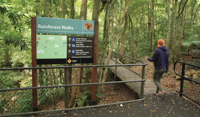 A woman walks past a sign at Minnamurra Rainforest in Budderoo National Park. Photo credit: Andrew Richards &copy; Andrew Richards