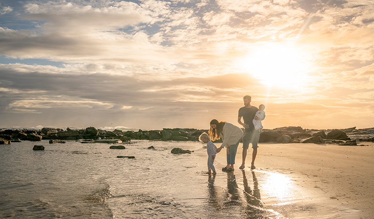 A family with young children on the beach at sunset, Bundjalung National Park.  Photo: John Spencer/OEH