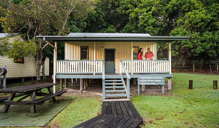 Hammonds Cottage, front exterior with visitors on the verandah, Woody Head, Bundjalung National Park. Photo: John Spencer/OEH