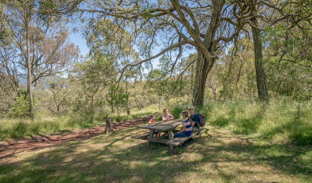 Family at a picnic table in Burning Mountain Nature Reserve. Credit: John Spencer &copy; DPE 