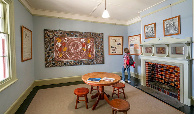 A woman viewing artwork at Cape Byron Information Centre in Cape Byron State Conservation Area. Photo: John Spencer/DPIE