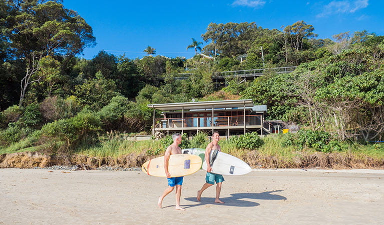Friends with surfboards heading off to the beach. Photo: Sera Wright/DPIE.