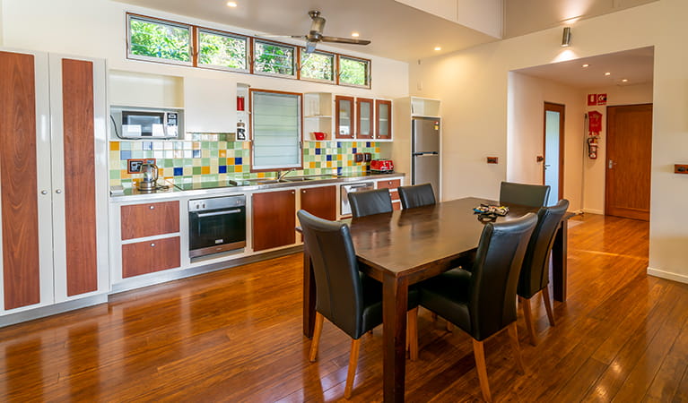 A colourful kitchen and large dining table at Mildenhall cottage. Photo: DPIE/John Spencer