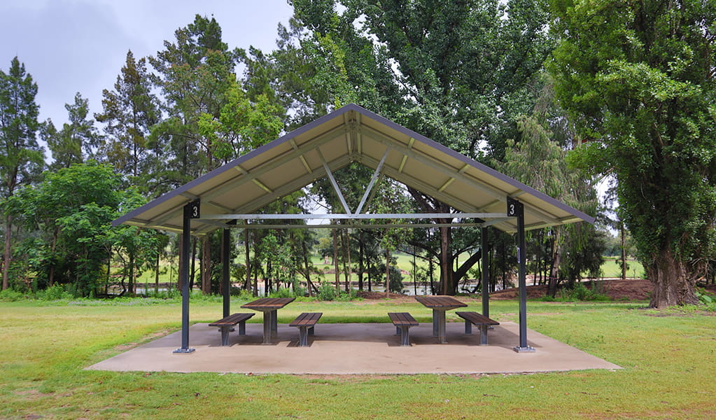 A picnic shed with two picnic tables underneath, at Cattai Farm picnic area in Cattai National Park, on the Hawkesbury River. Photo: David Bush &copy;DPE
