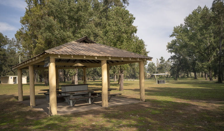 One of the picnic sheds at Cattai Farm picnic area in Cattai National Park, with barbecue and toilet facilities in the background. Photo: John Spencer/OEH