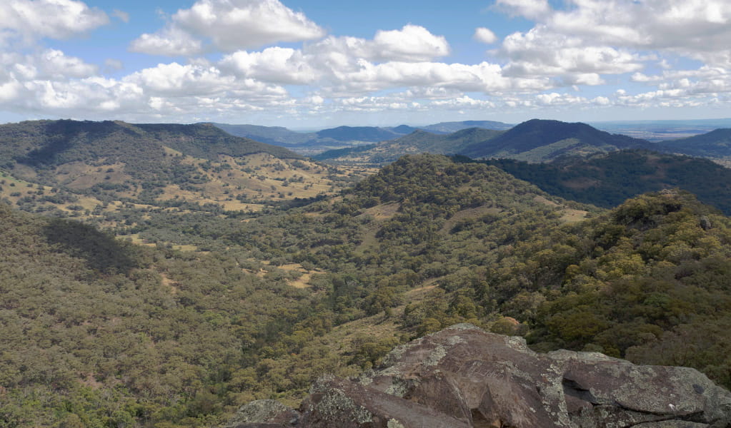  View past rocky ledge to hills and valleys stretching into the distance. Photo credit: Leah Pippos &copy; DPIE
