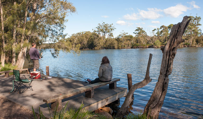 A person fishing at Wandandian Creek in Corramy Regional Park. Photo: Michael van Ewijk &copy; DPIE