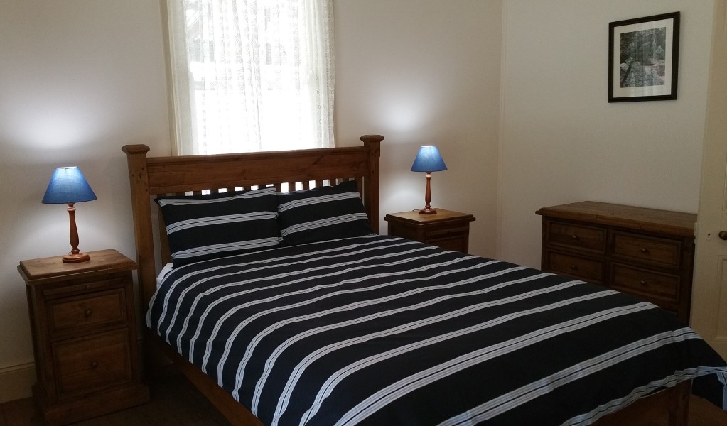 A bedroom with queen bed at Karamea Homestead in Curracabundi National Park. Photo &copy; Sean Thompson