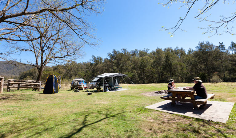 A couple having lunch on a park bench, Bendethera Valley campground, Deua National Park. Photo: Lucas Boyd Copyright:NSW Government