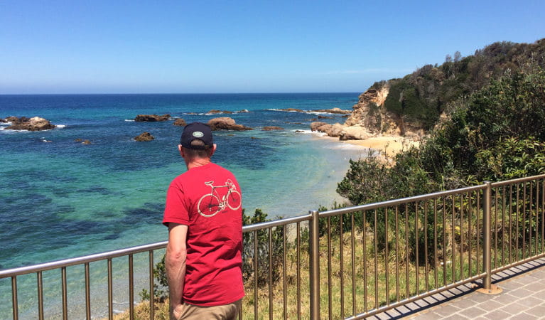 A male tourist enjoys beach and ocean views at Mystery Bay lookout, near Narooma in Eurobodalla National Park. Photo: Elinor Sheargold/OEH