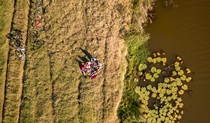 Aerial shot of friends picnicking on the banks of Woody Creek. Photo: John Spencer/OEH