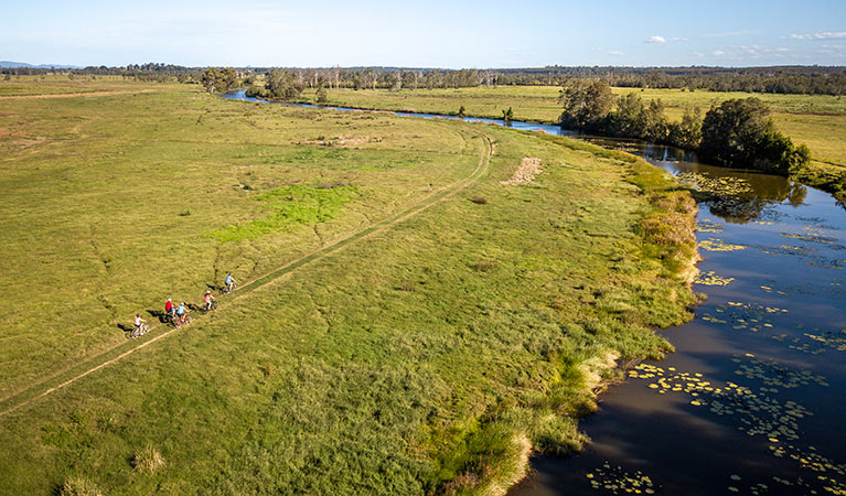 A group cycling along Woody Creek in Everlasting Swamp National Park. Photo: John Spencer/OEH