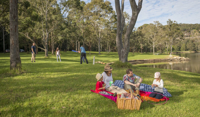 Family enjoying a picnic on the grass at Davidson Park picnic area in Garigal National Park. Photo: John Spencer/OEH